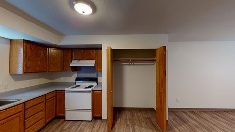 a kitchen with white appliances and wooden cabinets and a refrigerator