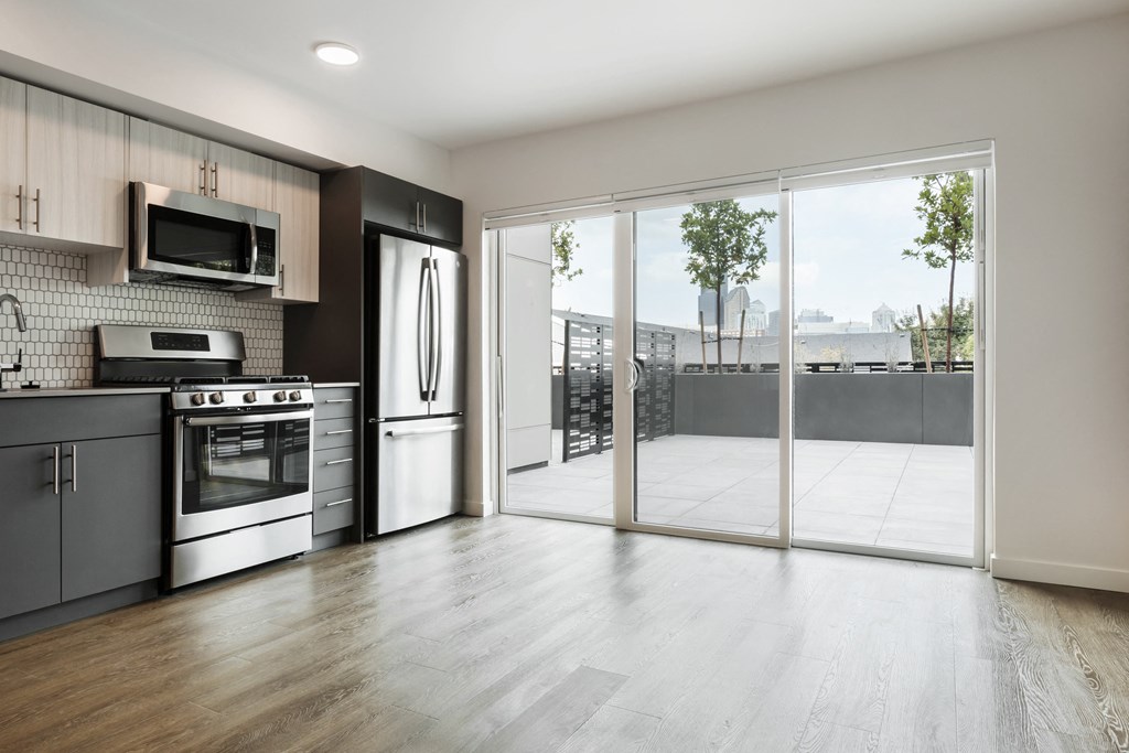 a kitchen with stainless steel appliances and a sliding glass door