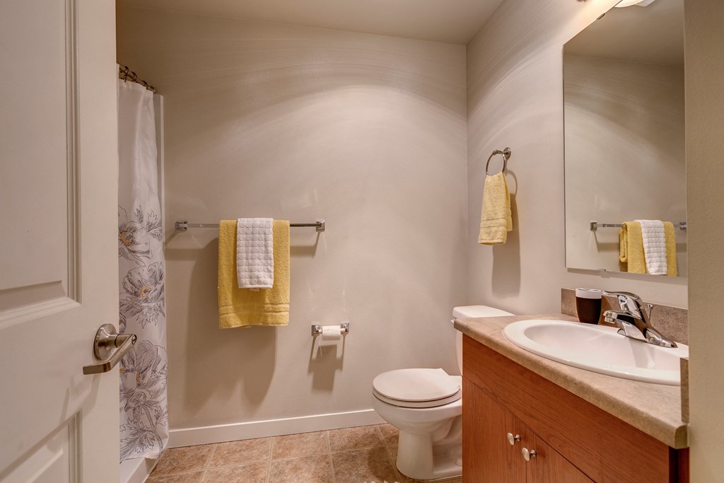 a small bathroom with a sink toilet and shower
