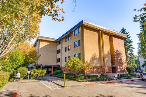 A large building with a parking lot in front of it.