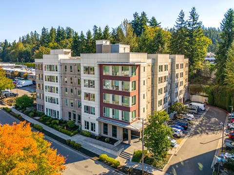 A large building with a parking lot in front of it.