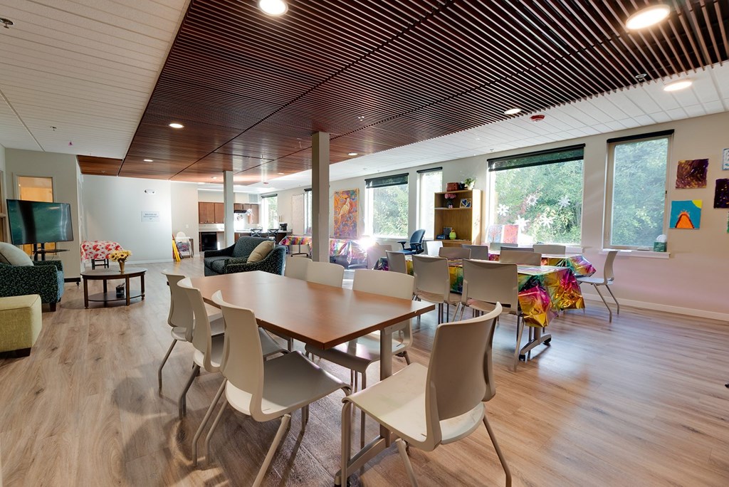 A conference room with a long table and chairs.