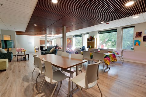 A conference room with a long table and chairs.