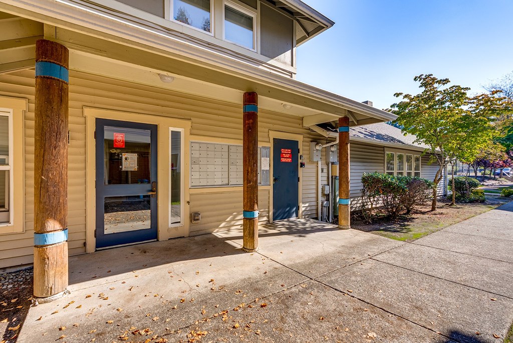 A building with a blue door and a red sign on the window.