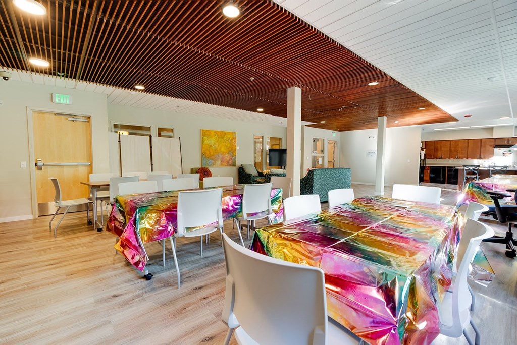 A room with tables covered in colorful material.