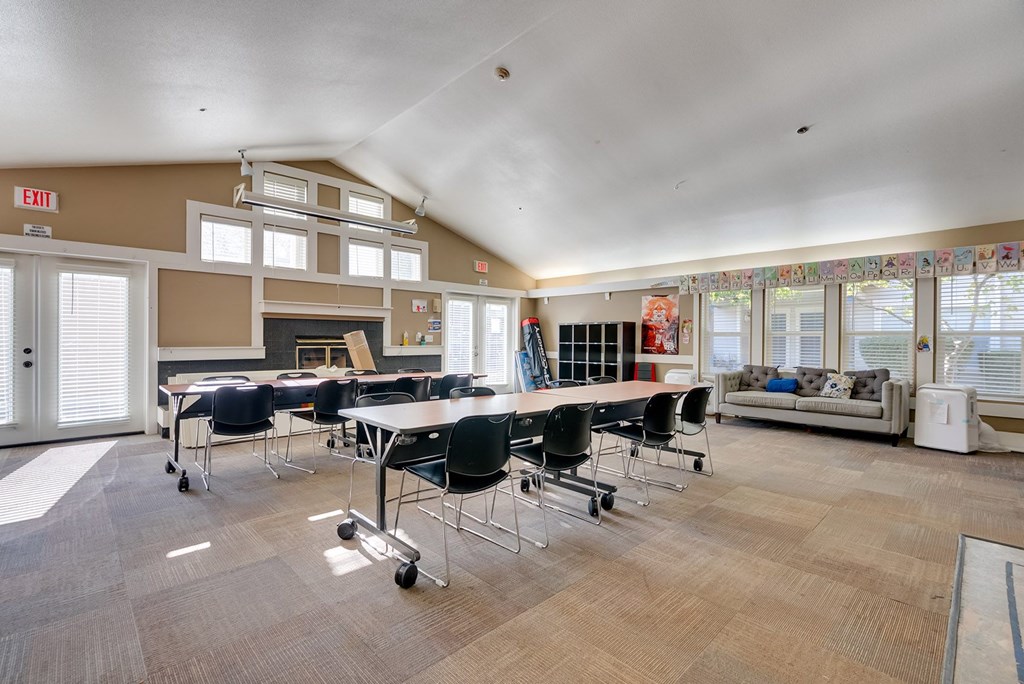 A conference room with a long table and chairs.