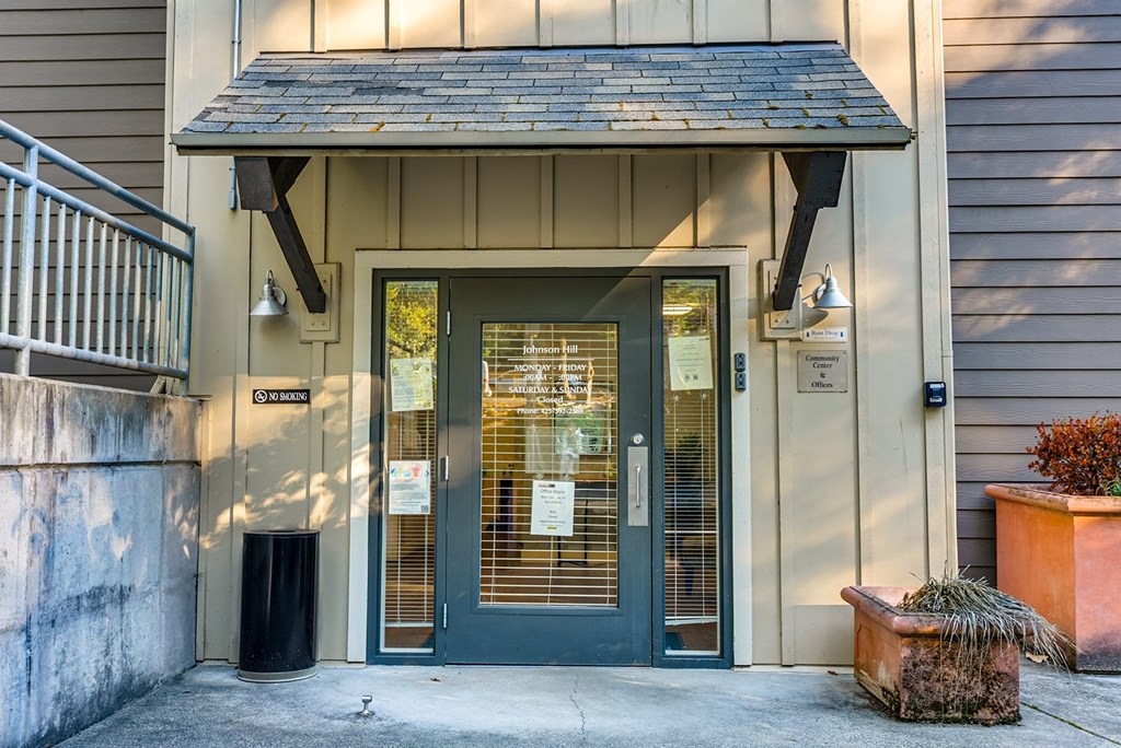 The front door of a building with a sign that reads "The Cottage".