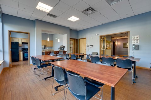 A conference room with a long table and chairs.