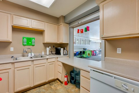 A kitchen with a white dishwasher and a sink.