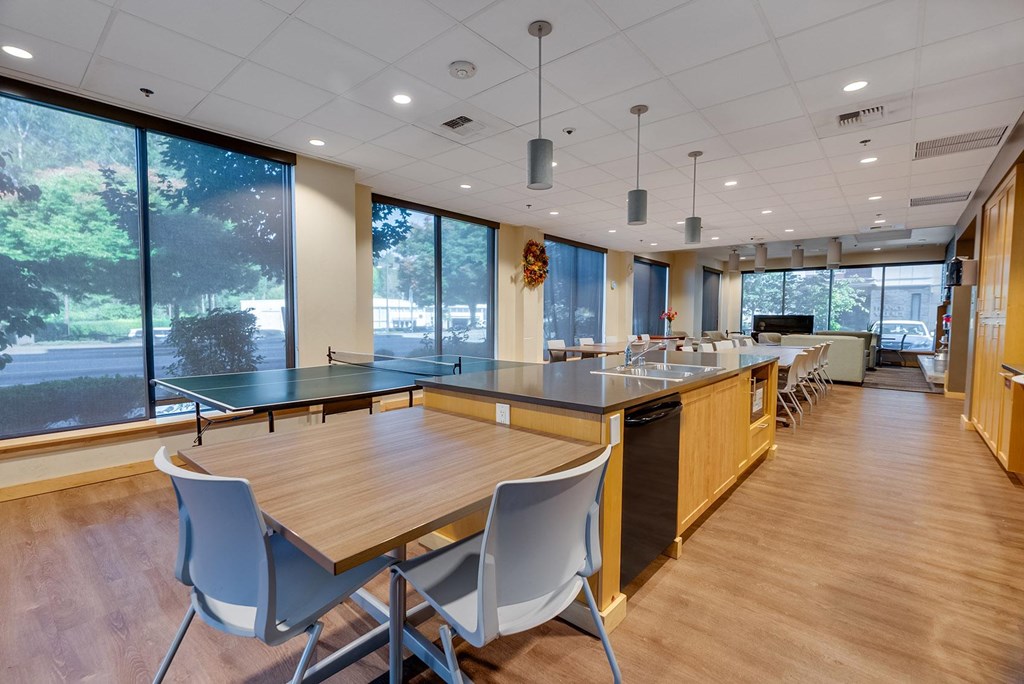 A modern kitchen with a table and chairs.