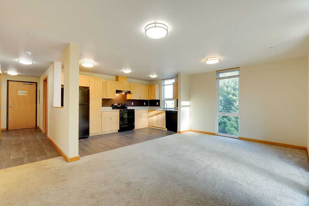 A spacious kitchen with a refrigerator, oven, and sink.