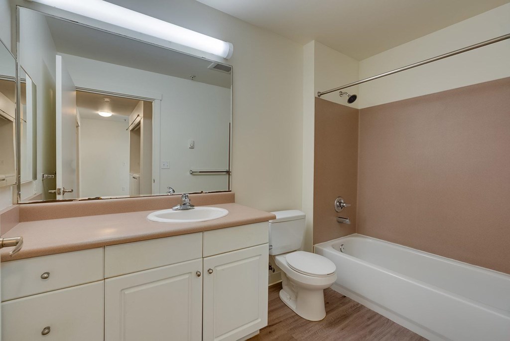 A bathroom with a sink, toilet, and bathtub.