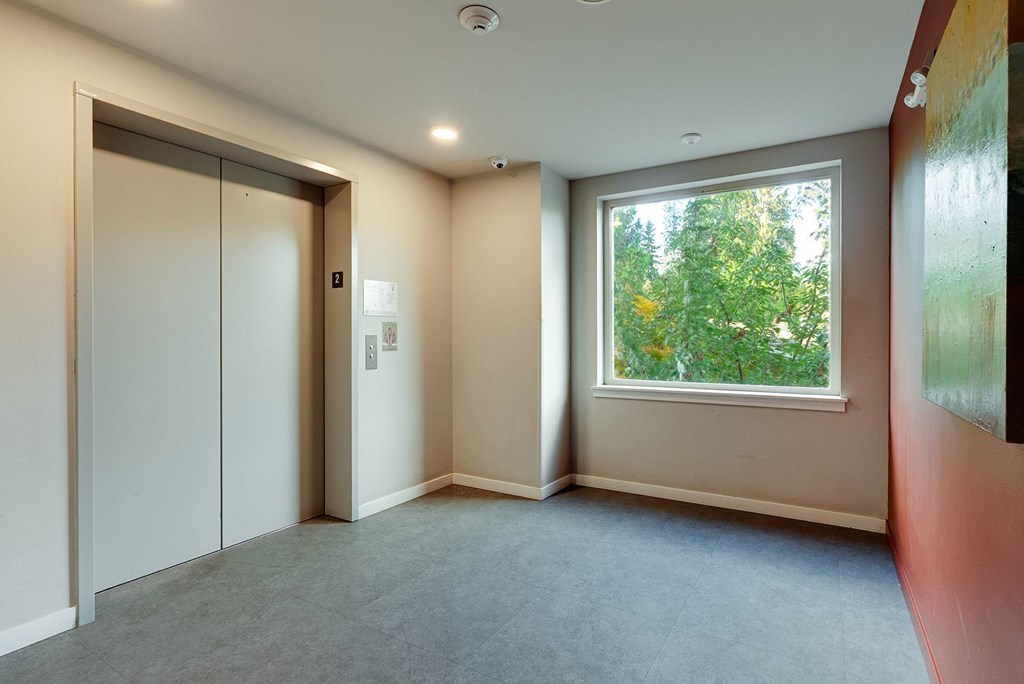 A room with a window and a closed door.