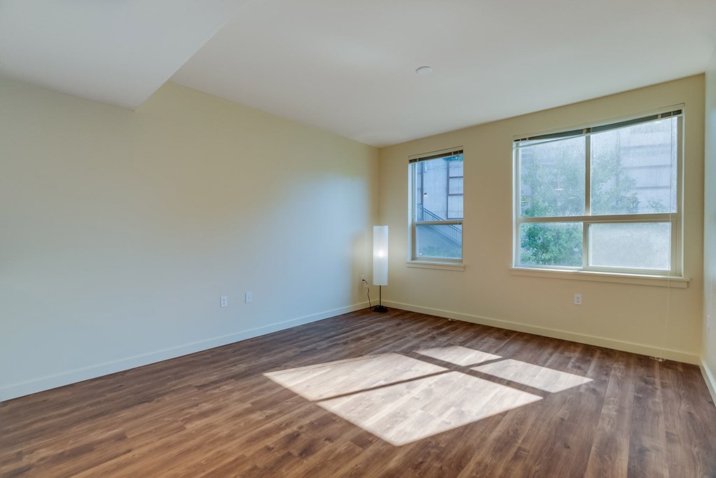 A room with wooden floors and a window.