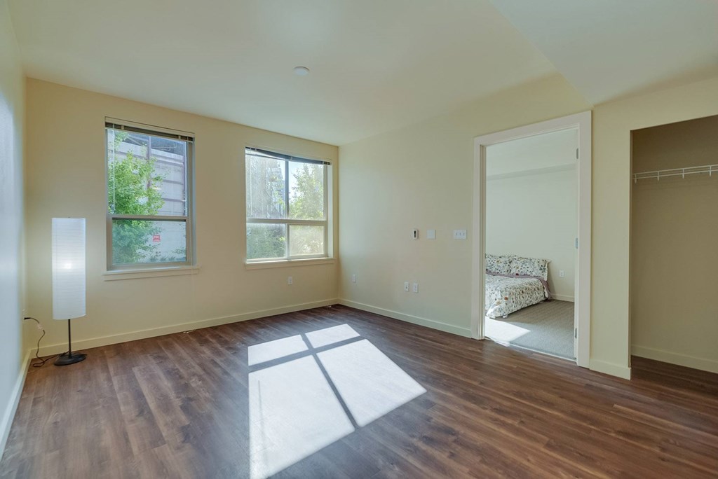 A room with wooden floors and a large window.