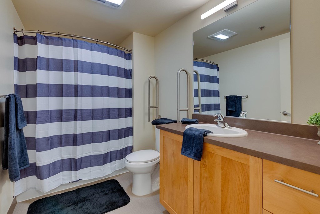 A bathroom with a blue and white striped shower curtain.
