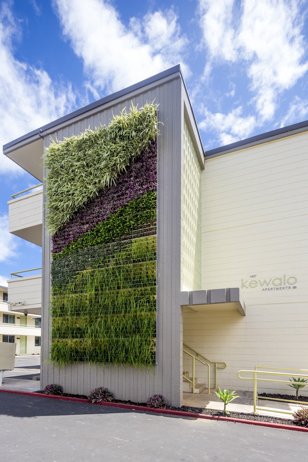 A building with a green wall on the side.