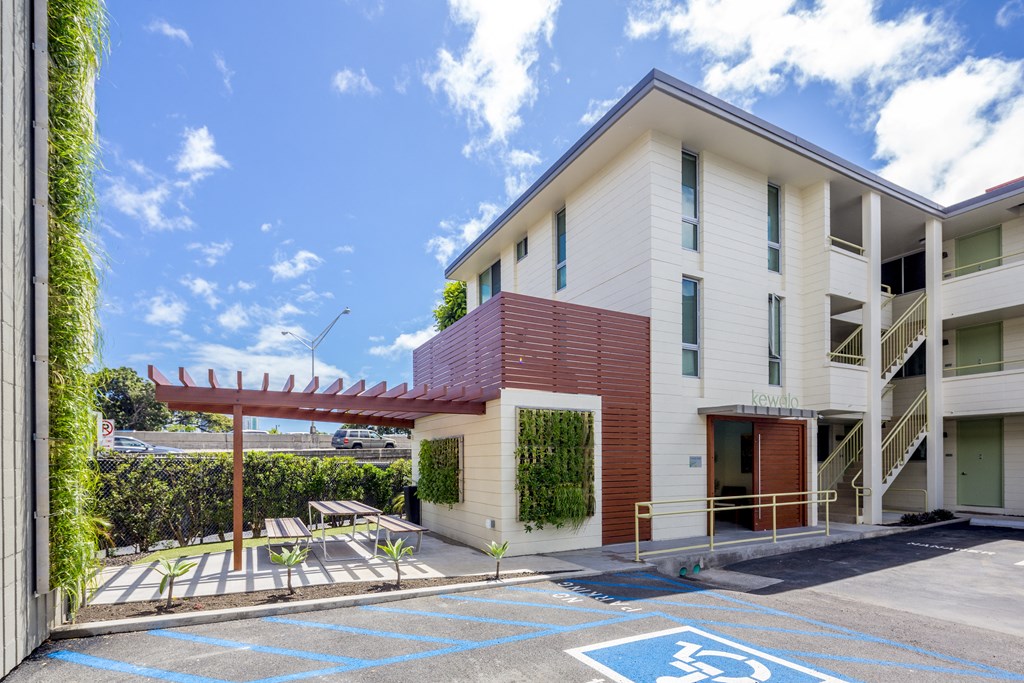 A building with a parking space marked with a wheelchair symbol.