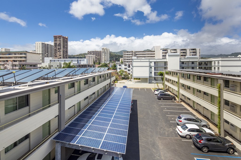 A parking lot with solar panels on the roof.