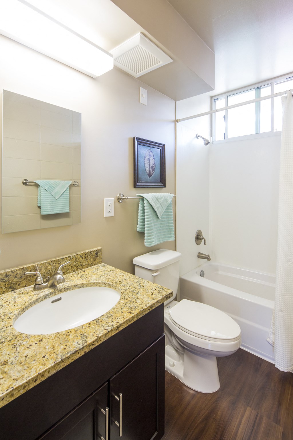 A bathroom with a sink, toilet and bathtub.
