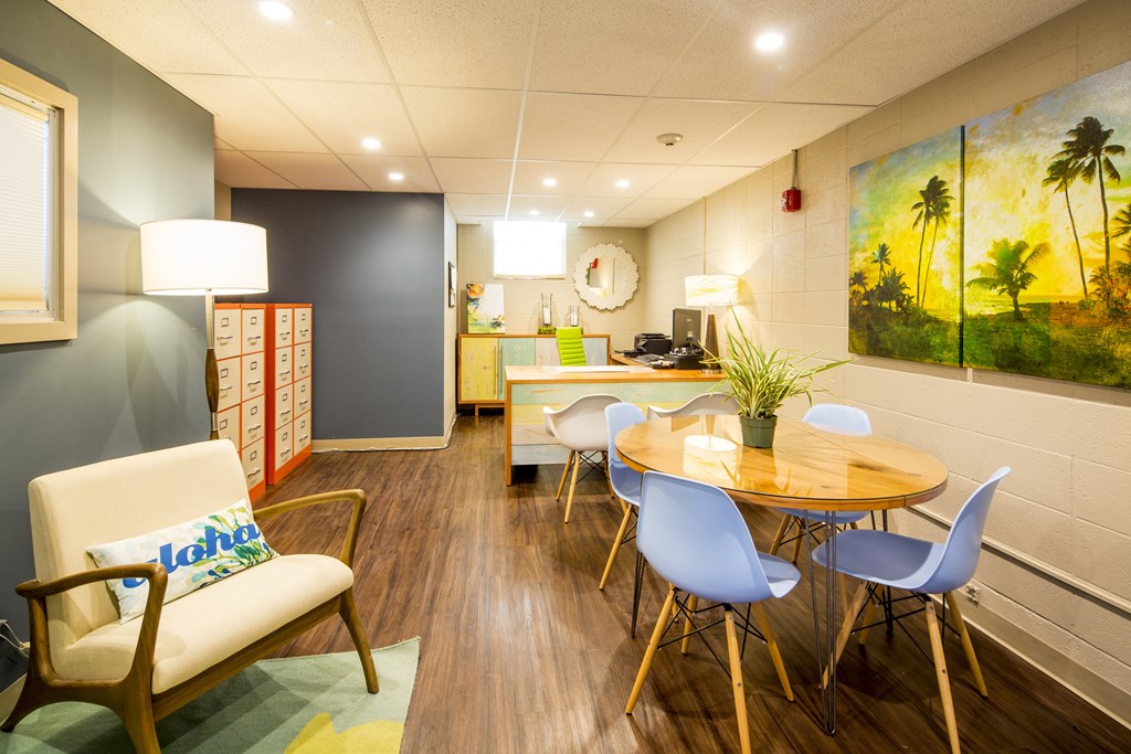 A room with a wooden floor and a painting on the wall.