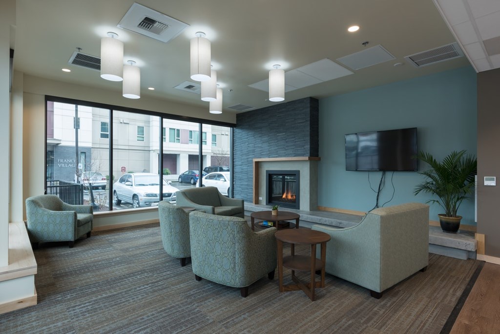 A living room with a fireplace and a flat screen TV.