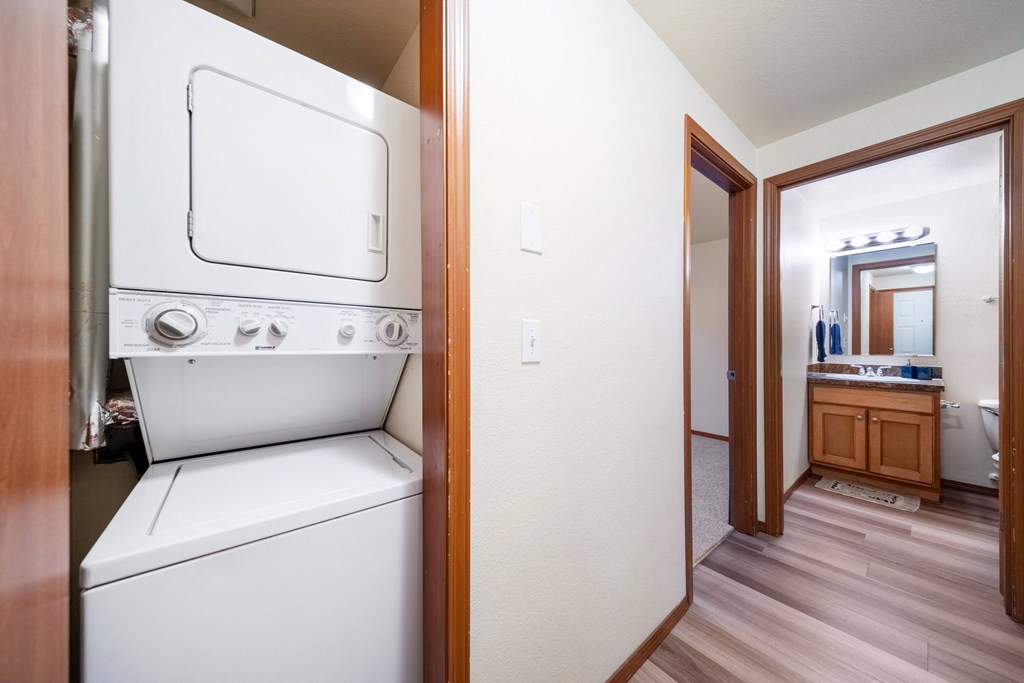 A white dishwasher is in a kitchen next to a white oven.