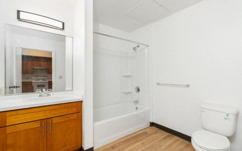 A white toilet sits next to a walk-in shower in a bathroom.