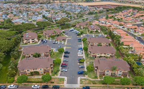 an aerial view of a neighborhood of houses with cars parked