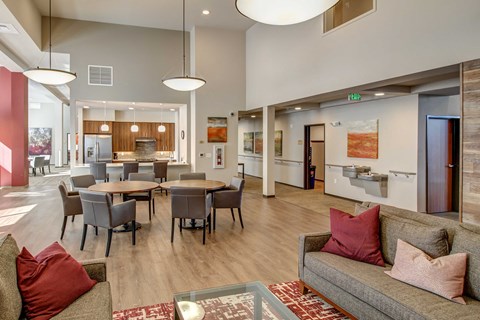 a living room and dining room with a table and chairs