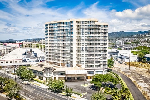 an aerial view of a tall building in the middle of a city