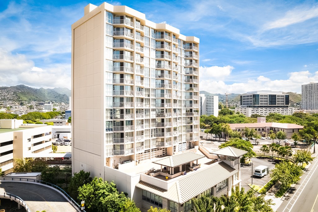 an aerial view of a large white building with many balconies