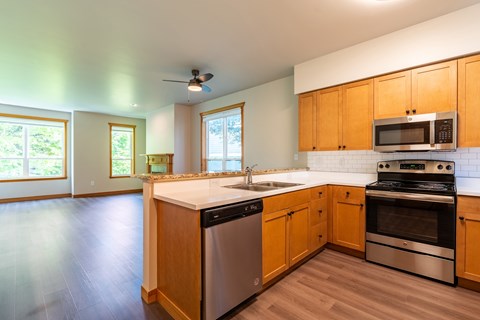 A kitchen with wooden cabinets and stainless steel appliances.