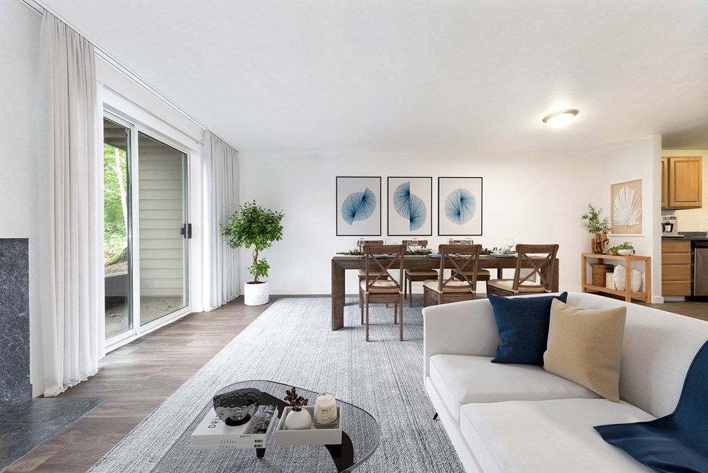 a living room with a white couch and a glass coffee table