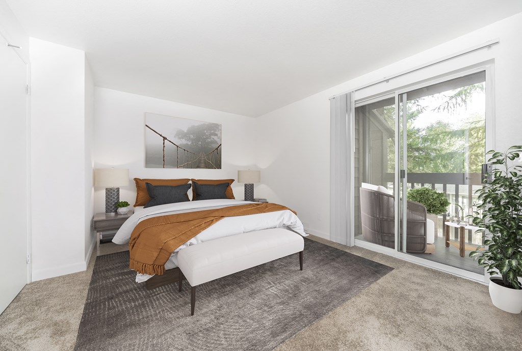 a bedroom with a bed and a sliding glass door to a balcony