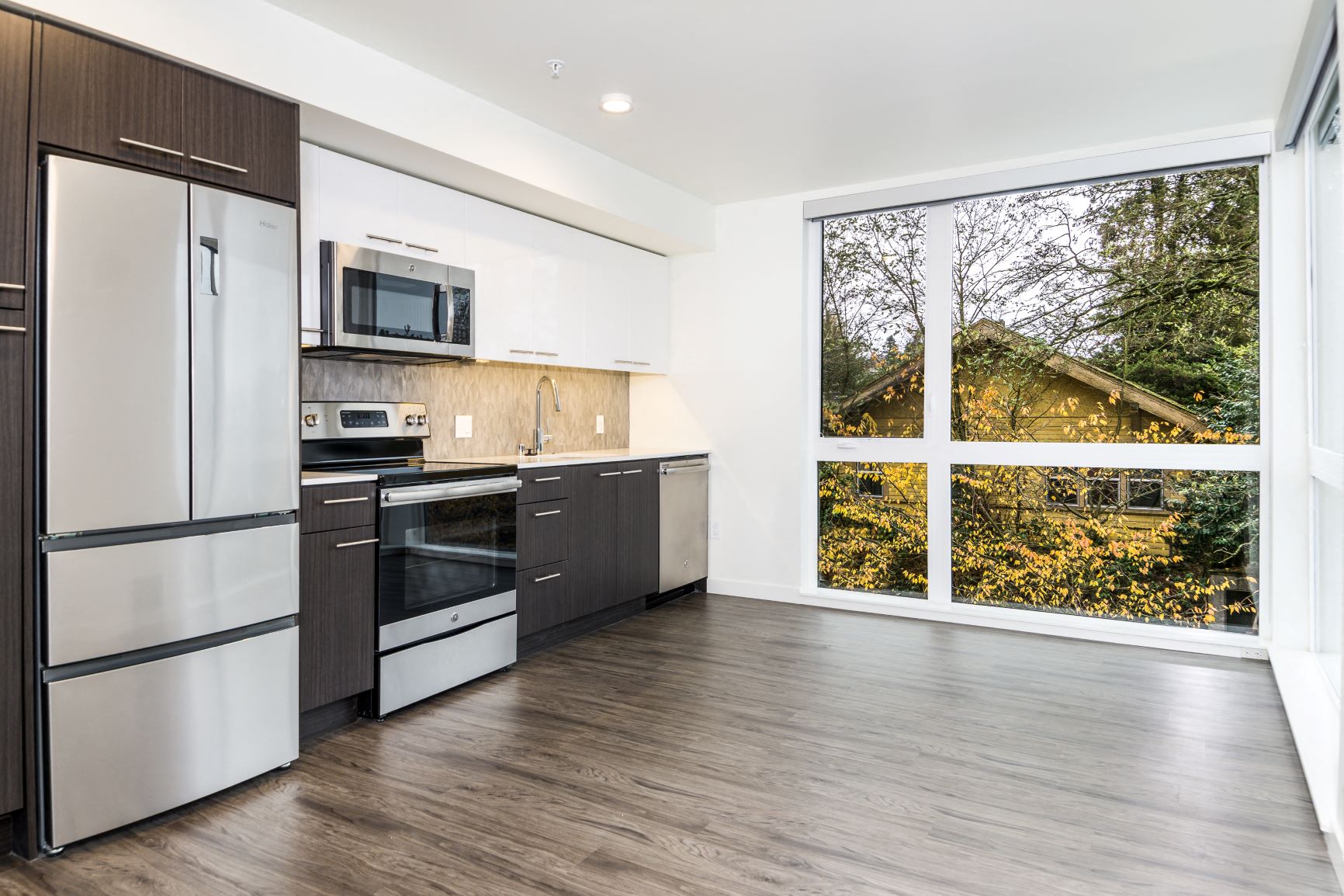 a kitchen with stainless steel appliances and a large window