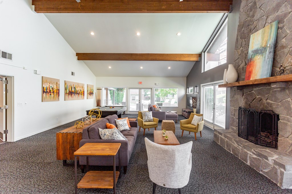 a living room with couches and chairs and a fireplace