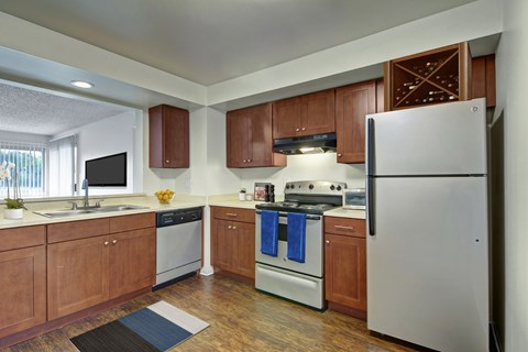 A kitchen with wooden cabinets and a white refrigerator.