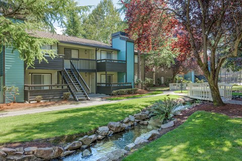 A house with a blue exterior and a white picket fence.