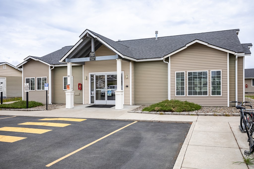 the front of a house with a bike parked in front of it
