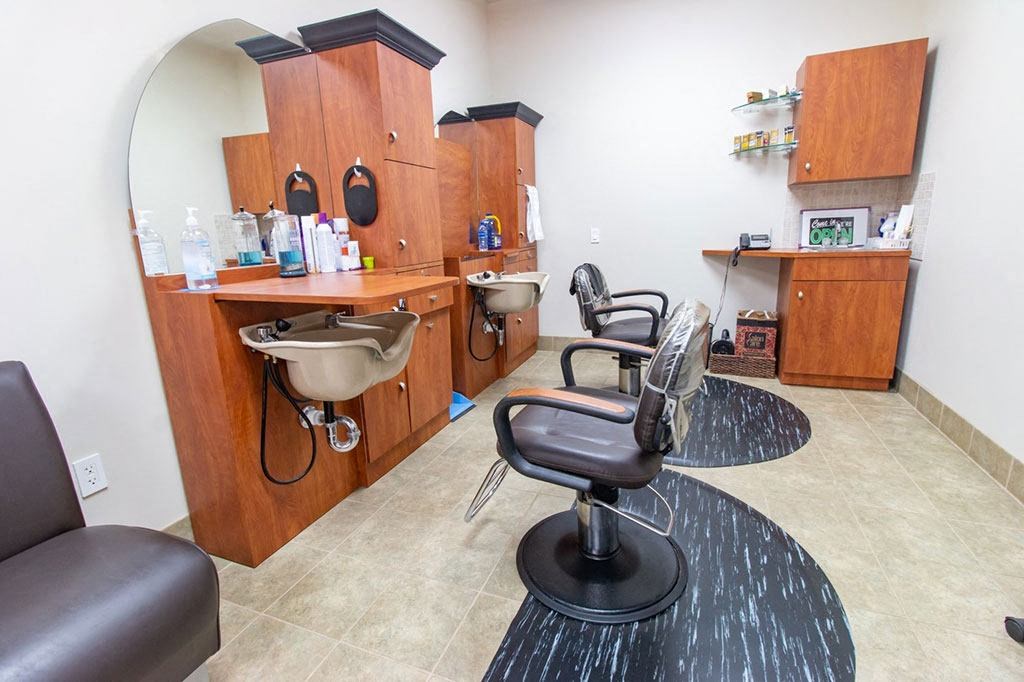 a salon room with two chairs and a barber chair