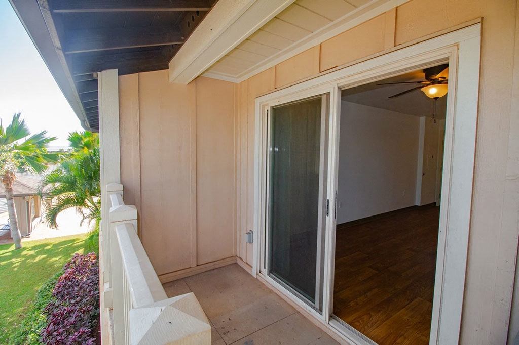 a patio outside of a house with a sliding glass door