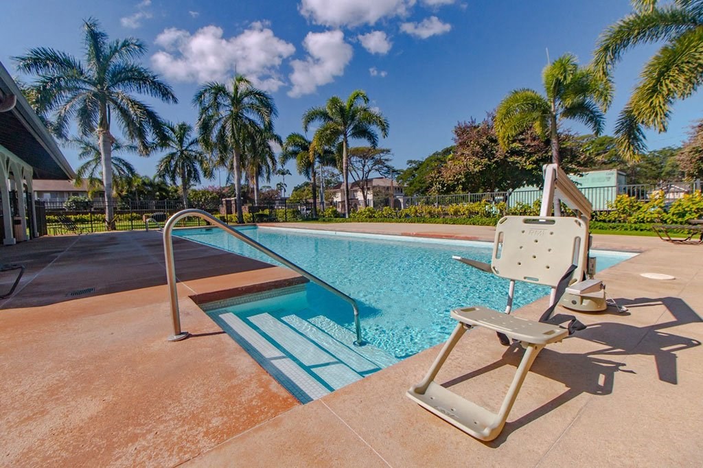 a swimming pool with a chair next to it