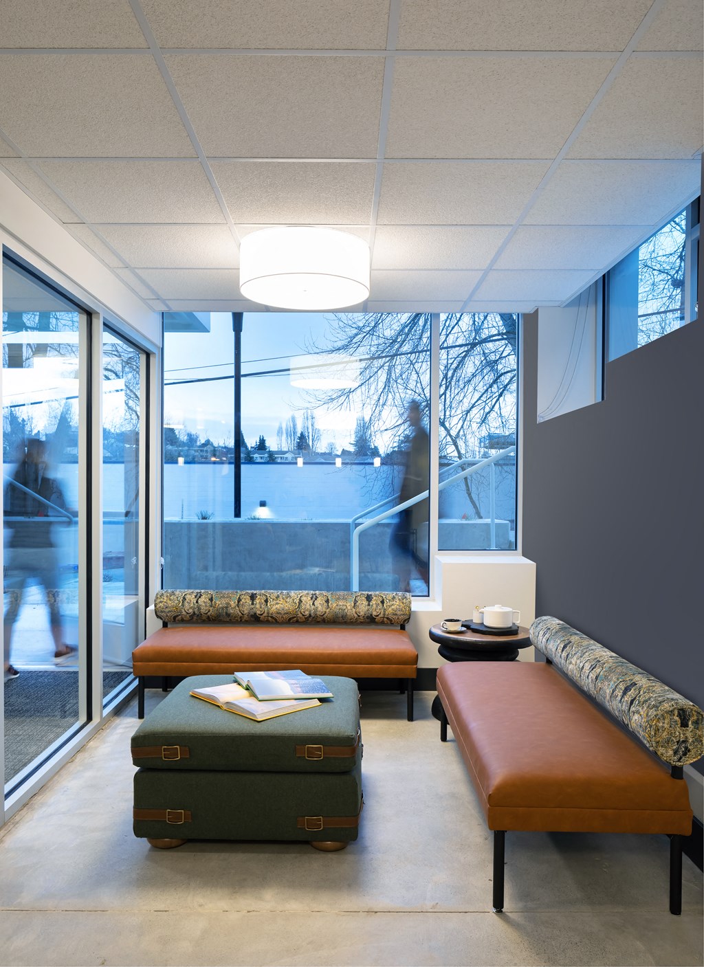 a waiting room with two couches and a table with luggage