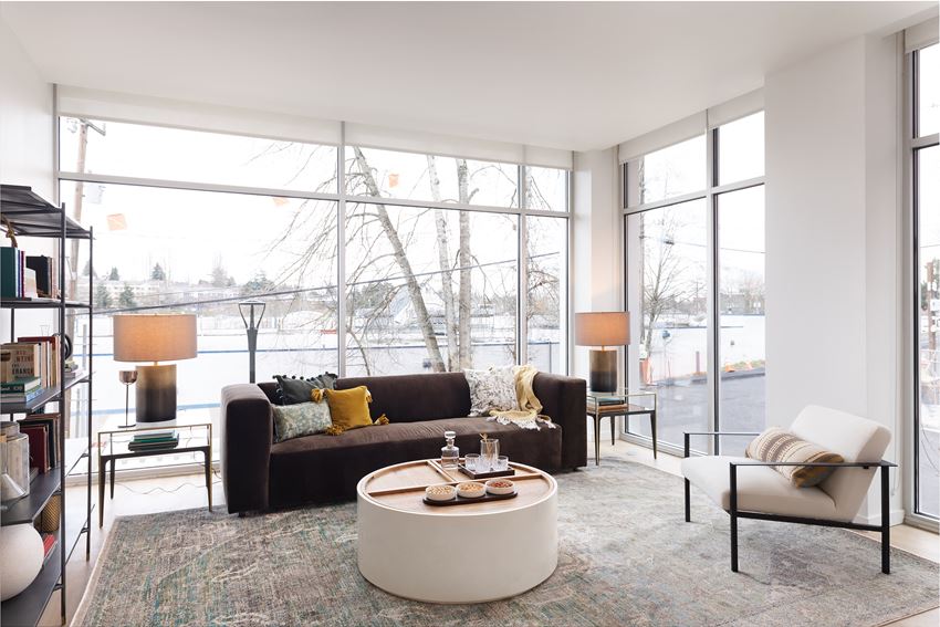 a living room with a brown couch and a white coffee table