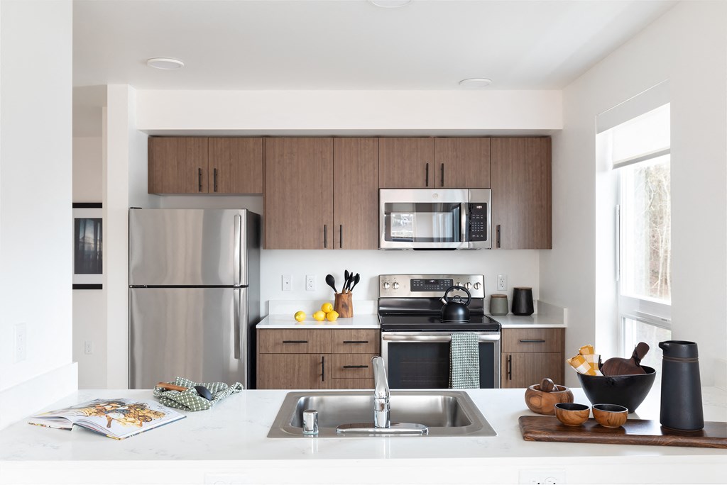 a kitchen with stainless steel appliances and wooden cabinets
