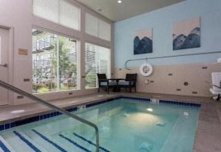 a swimming pool in a room with a large window