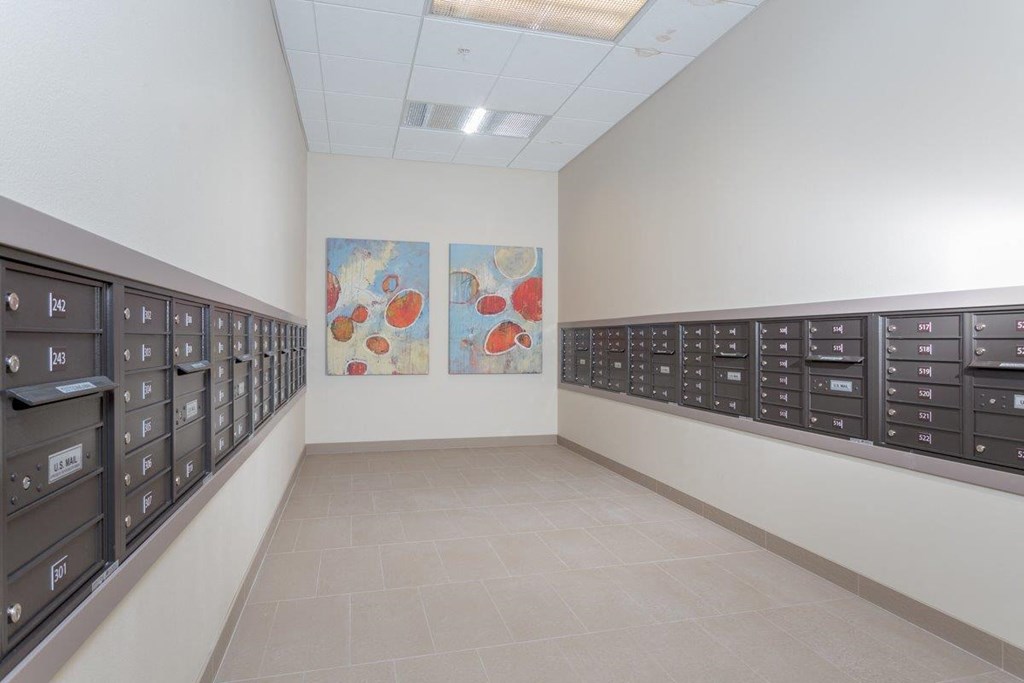 a locker room with lockers and paintings on the wall