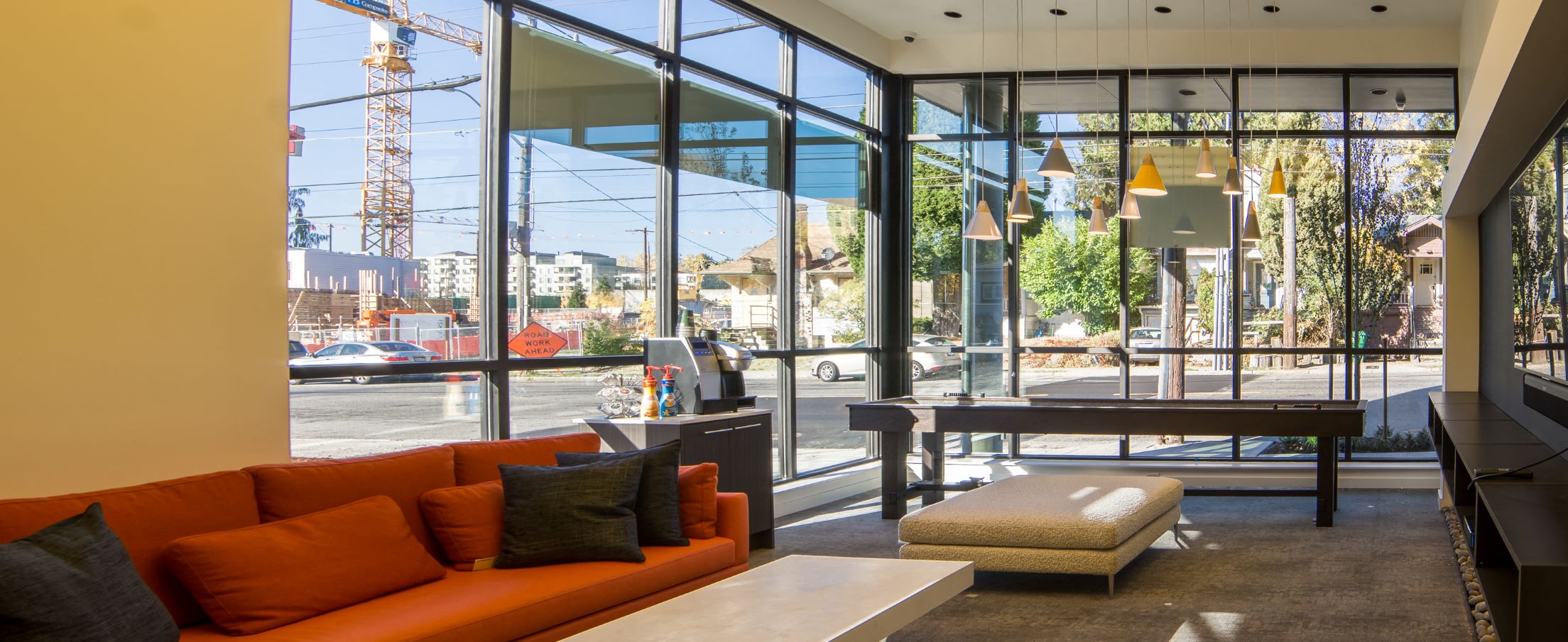 the lobby of a building with a orange couch and a table
