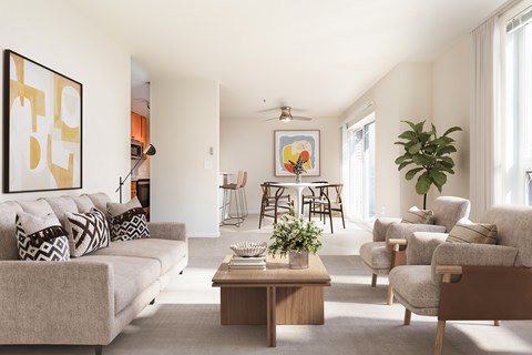 A living room with a grey couch, a coffee table, and a painting on the wall.